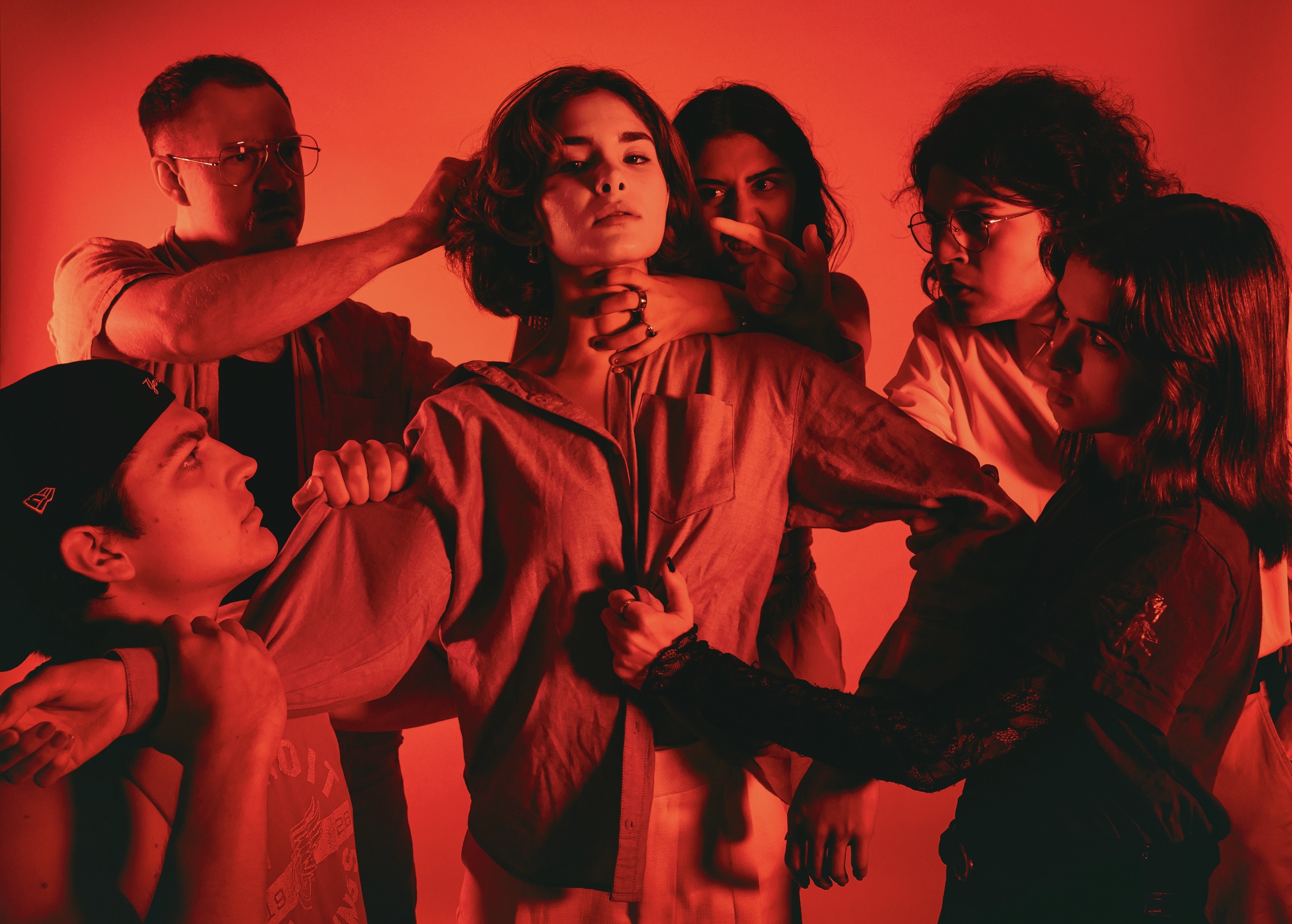 The ensemble framed against lockers and stage haze